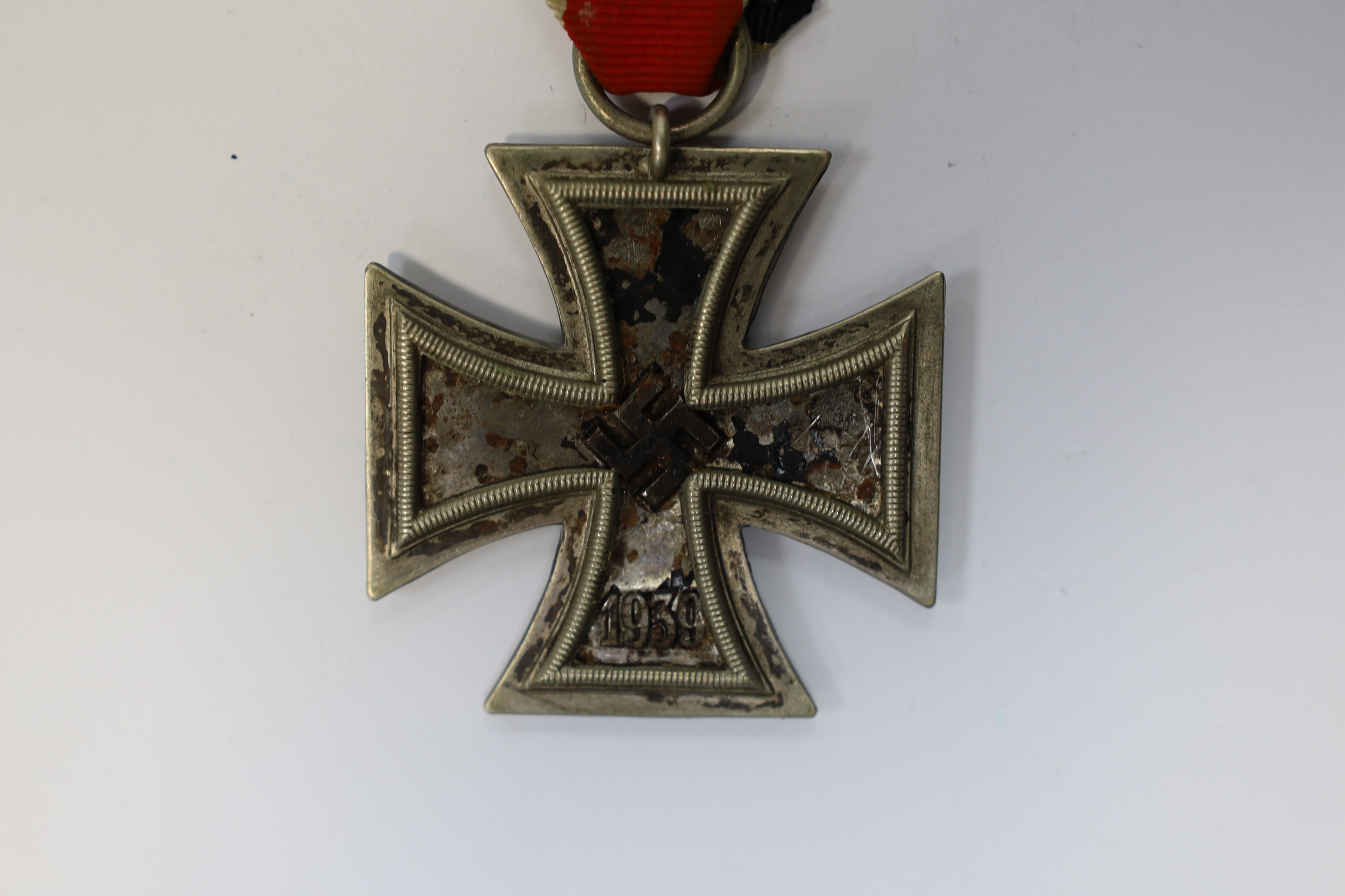 A WWII Iron Cross. Condition - poor, black paint now mainly missing from surface.